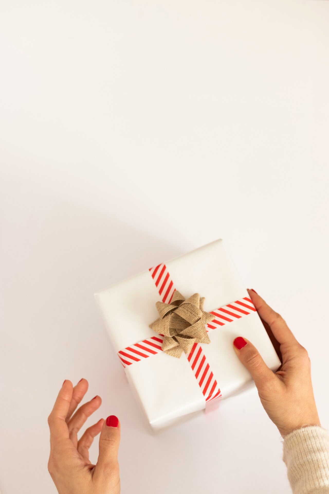 having white gift box with red ribbon