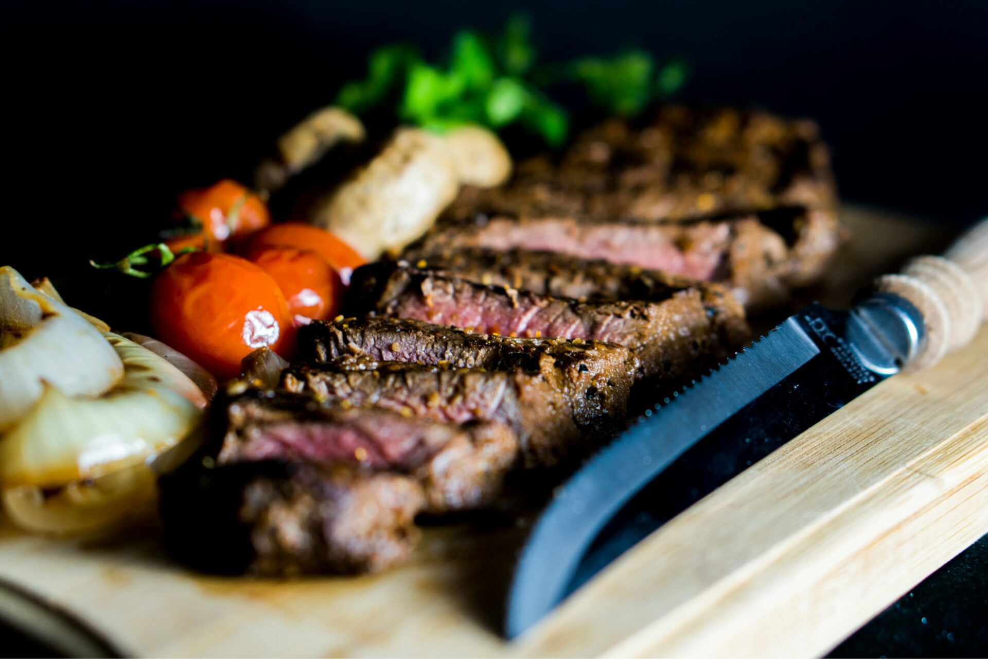 grilled steak with onion,tomato and steakknife